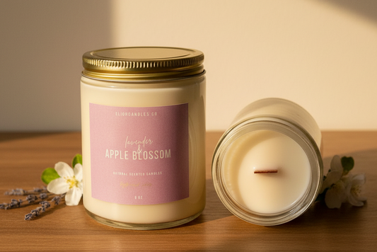 Two candles on a wooden surface with a soft light background